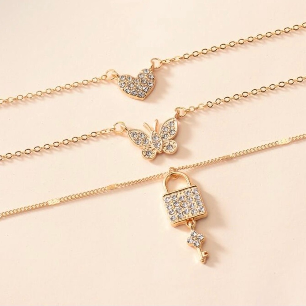 Gold Layered Necklace Set with Heart, Butterfly, and Lock Pendants - Picture 5 of 6